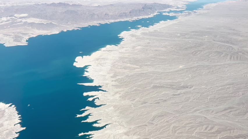A high angle wide aerial view of Lake Mead in April, 2022.	