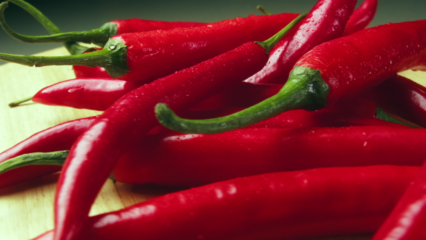 Ripe red hot chili peppers are a culinary delight and the number one cash crop in New Mexico, USA. They are a delicious part of Mexican food in the southwest. Left to right 4K close-up slider video. Royalty-Free Stock Footage #1093126743