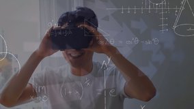 Mathematical equations floating against asian boy wearing vr headset in class at school. School and education technology concept - Powered by Shutterstock - Get 15% off with code: PIKWIZARD15