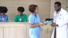 Reception area in modern hospital with patient information counter and group of professional doctors and nurses working in medical center health services. Concept of medical and wellness tourism. - Powered by Shutterstock - Get 15% off with code: PIKWIZARD15