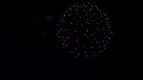 Awesome Real Firework on Deep Black Background Sky on Fireworks festival from river bank over night city lights in summer on 4th of July, Independence day in USA 2022. High quality 4k raw video