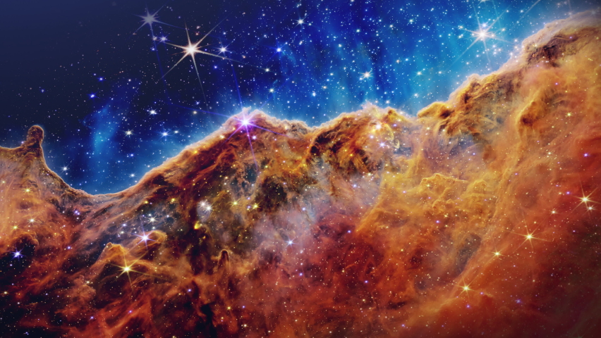 Fly towards the Great Carina Nebula in the constellation of Carina. Zooming into the Cosmic Cliffs at the edge of NGC 3324. Wide-field view of the complex area of bright and dark nebulosity. Royalty-Free Stock Footage #1093137163