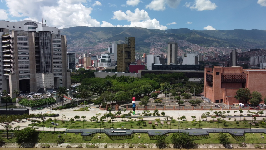 Aerial view of the colorful stacked stones in river park (Parques del rio) Medellin Colombia with buildings in the background