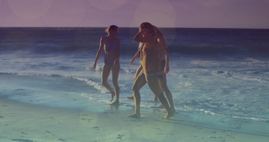 Animation of glowing lights over group of diverse female friends by the sea. Friendship, summer and holiday concept digitally generated video. | Shutterstock HD Video #1093139511