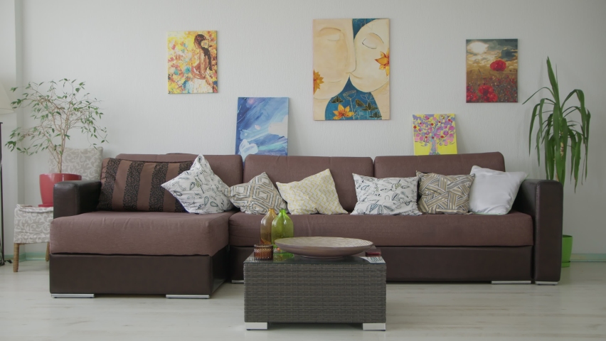 4K. A bride in a bathrobe puts her wedding dress on the sofa