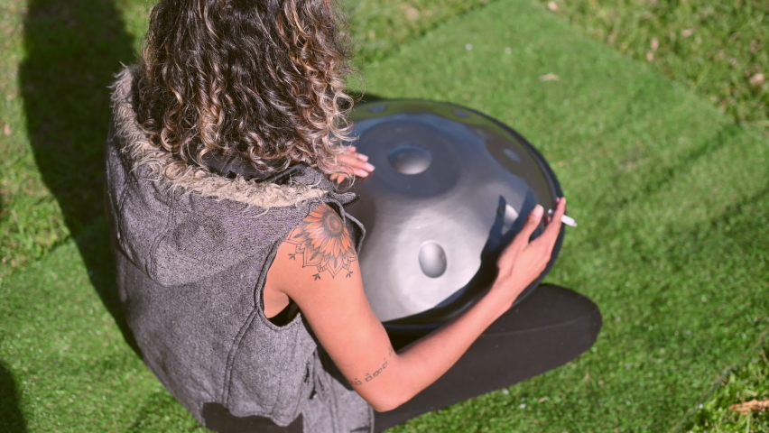 High angle view of woman playing steel pan