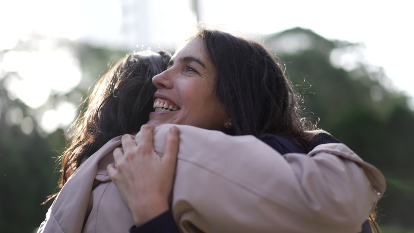 Two female friends hugging each other at park. Happy Women embrace reunion outdoors | Shutterstock HD Video #1093144939