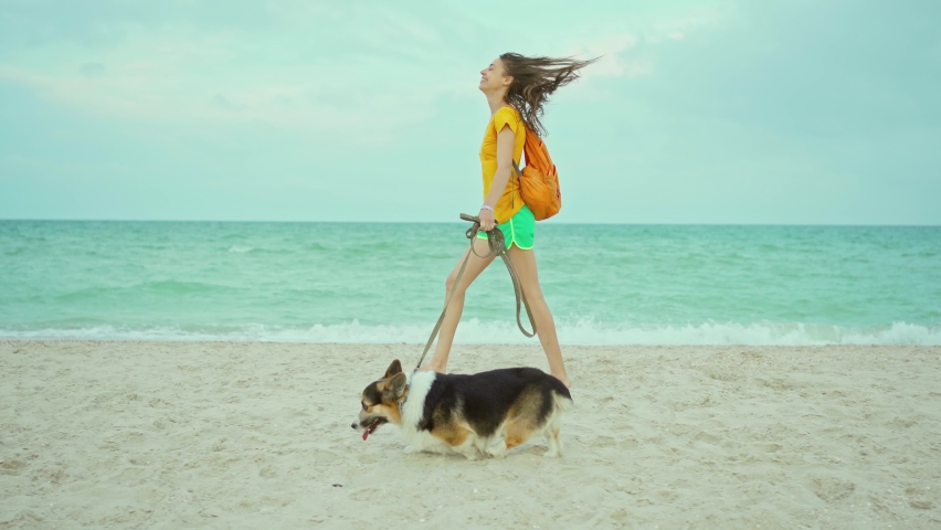 Happy smiling girl playing outdoors and spending time together with her pet cute corgi dog, concept slow living | Shutterstock HD Video #1093150461