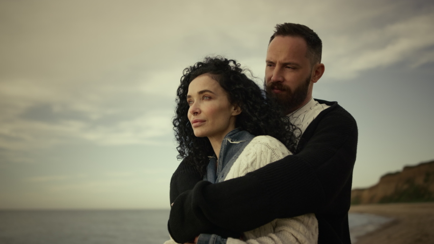 Couple hugging enjoying beach day vacation family trip at sea background. Relaxing two people cuddling embracing together at ocean shore close up. Multiracial lovers share lovely moment. Care
