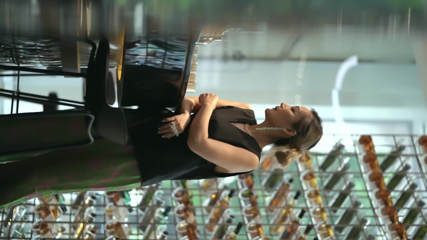 Asian beauty standing beside bar counter drinking whisky | Shutterstock HD Video #1093152975