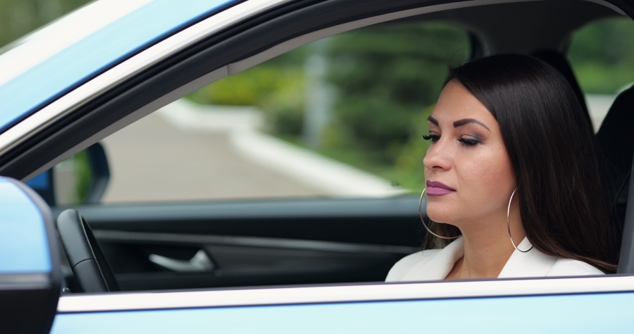 Adult woman driver feels sick sneezing in car. Businesswoman touches face with napkin and makes sure about appearance sitting in black leather cabin | Shutterstock HD Video #1093155451