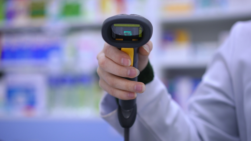 Front view close-up bar code reader in female hand with red light flashing. Unrecognizable woman pharmacist scanning QR code in drugstore in slow motion Royalty-Free Stock Footage #1093157293
