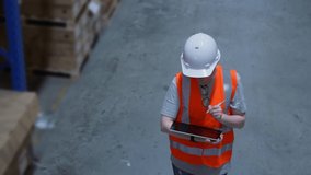 Business concept of 4k Resolution. An employee is checking the goods with a tablet in the warehouse. - Powered by Shutterstock - Get 15% off with code: PIKWIZARD15