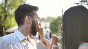 couple in love eating ice cream.Cheerful couple treat each other with delicious ice cream. - Powered by Shutterstock - Get 15% off with code: PIKWIZARD15