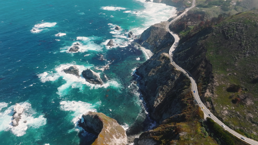 Pacific Ocean washes onto the beautiful seashore of California, on Monterey coast. Pacific Coast Highway runs by Big Sur nature park, along incredibly scenic coast with sea rocks and powerful waves | Shutterstock HD Video #1093172595