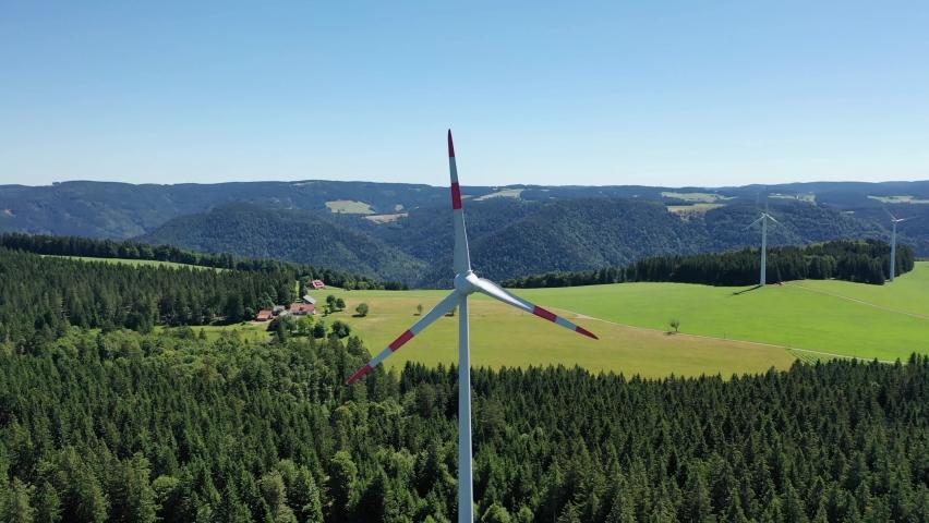 Aerial video of wind power plant on the hilltop between fir trees. St. Peter, Black forest, Germany.
Concept  for regenerative energy and energy crisis. | Shutterstock HD Video #1093173799
