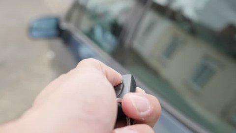 Modern gray car closing with digital key touch button 4K 2160p UltraHD footage - Car   locking with wireless button key 4K 3840X2160 UHD video