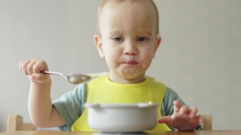 Eating Baby Child Sitting Table Holding Stock Footage Video (100% ...