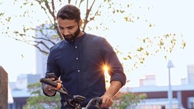 Indian business man holding smartphone using bike rental digital phone app scanning qr code to rent electric bicycle in city public eco transport mobile application standing on urban park on sunset. - Powered by Shutterstock - Get 15% off with code: PIKWIZARD15