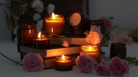 A set of different aroma candles in brown glass jars and flowers. Scented handmade candle. Soy candles are burning in a jar. Aromatherapy and relax in spa and home. Fire in brown jar. Dark evening - Powered by Shutterstock - Get 15% off with code: PIKWIZARD15