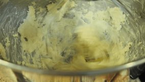 Close up looking down at butter in a stand mixer being mixed.