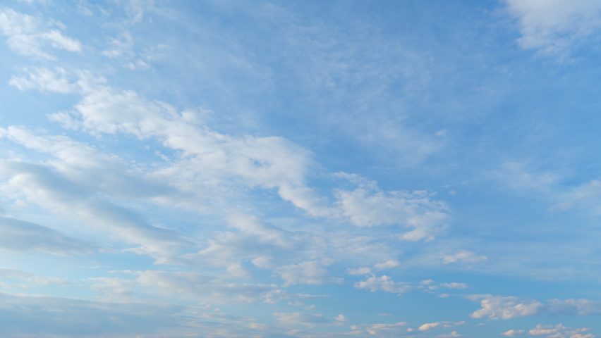 Light high clouds slide on sky. Layer of clouds in blue sky moving horizontal in opposite direction. Time lapse. Royalty-Free Stock Footage #1093200109