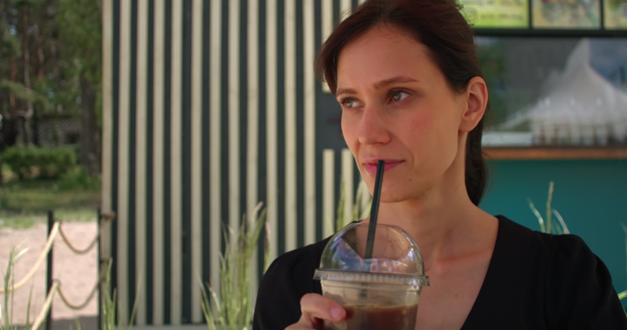 Woman in sunglasses drink latte in cafe. Modern lifestyle in big city | Shutterstock HD Video #1093201303