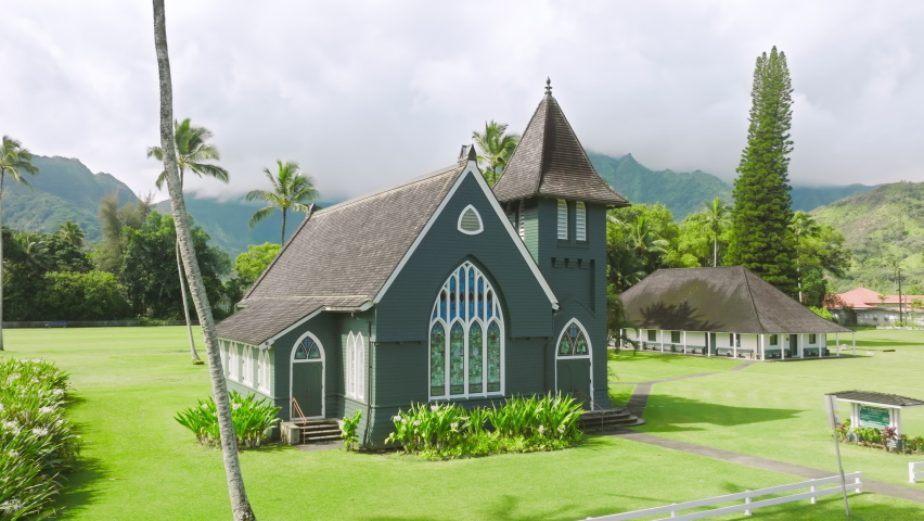 Waioli Huiia Church in Haena town on North Shore of Kauai island, Hawaii on sunny summer day. Historic Christian church in American gothic style with tower bell on cinematic island nature background