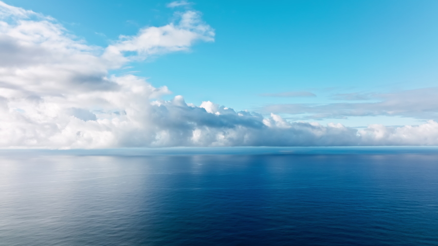 Epic flight over perfect deep blue sea with scenic white clouds in blue sky. Endless horizon seen in distance, cinematic blue depths of perfect calm ocean. Beautiful calm sea, evening sky background | Shutterstock HD Video #1093207681