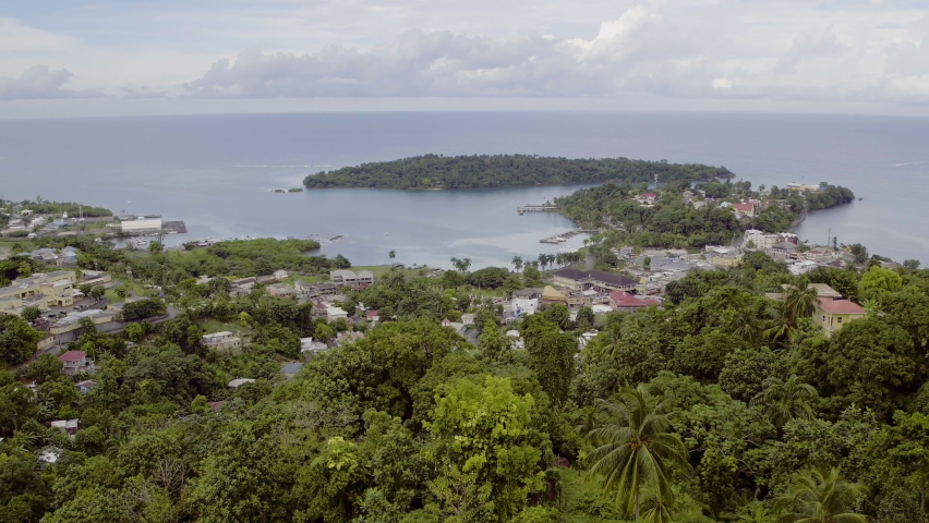 Aerial view of Port Antonio in Jamaica looking towards Navy Island and peaking down into the town and the west Harbour. Royalty-Free Stock Footage #1093208427