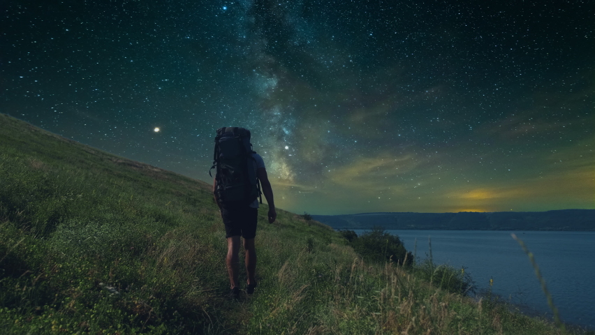 The man trekking along the mountain coast on starry sky background. slow motion | Shutterstock HD Video #1093215273