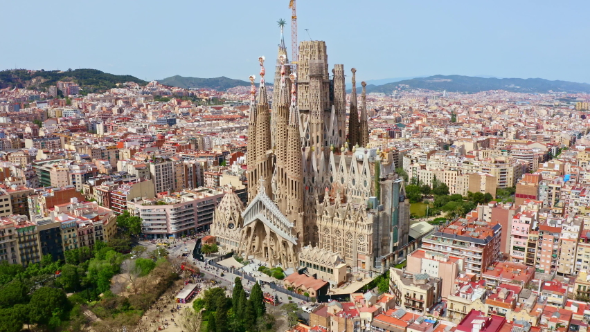 Panorama aerial view flying drone shot over famous Spanish city Barcelona tourism traveling place top outside exterior facade catholic religious church La Sagrada Familia cathedral temple in Spain Royalty-Free Stock Footage #1093217365