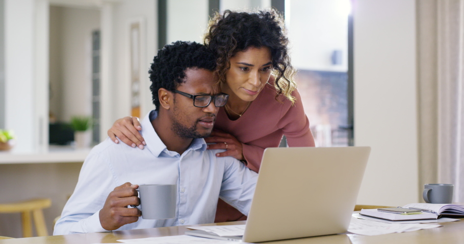 Stressed couple on laptop looking at debt finance paper work, trouble paying insurance loans or online ebanking together at home. Serious, unhappy man and woman anxious about bills, tax and mortgage Royalty-Free Stock Footage #1093218193
