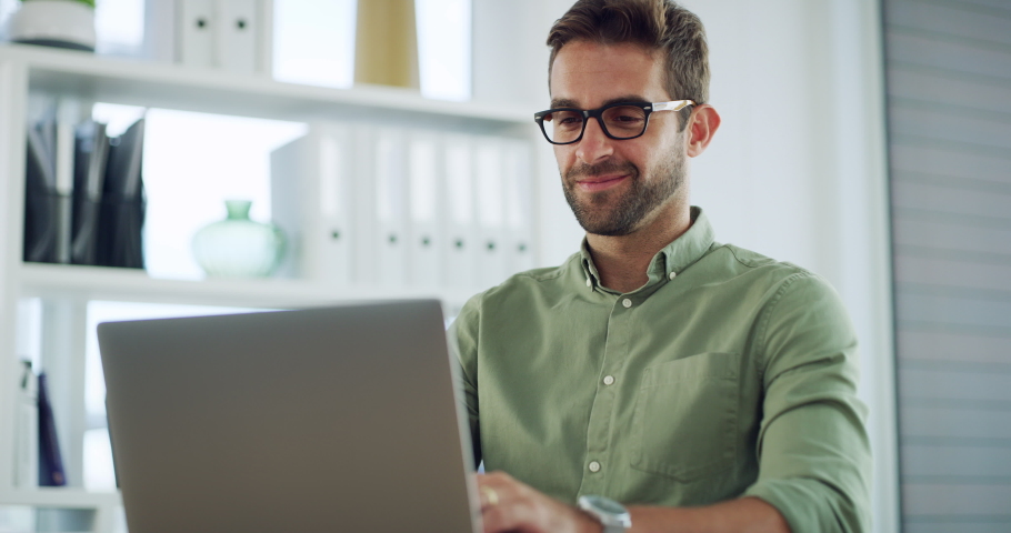 Creative entrepreneur typing on laptop, browsing the internet and searching customer emails on office technology. Smiling, happy and ambitious business man working on innovation and a startup vision | Shutterstock HD Video #1093218423