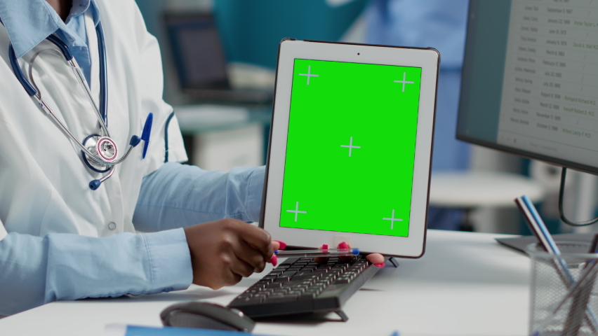 Female doctor holding tablet with greenscreen at checkup with paralyzed patient. Using blank copyspace background with isolated display and chromakey mockup template. Close up. | Shutterstock HD Video #1093219421