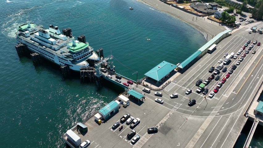 Orbiting aerial shot of cars loading onto the Clinton ferry on Whidbey Island.
