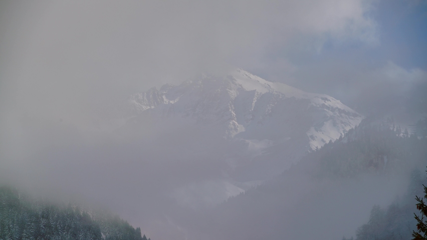 Mount Washington is a peak in the Olympic Mountains of Washington state.The mountain is located in the Mount Skokomish Wilderness.Fog dissipating summit emerges.Snowy nature background 8K