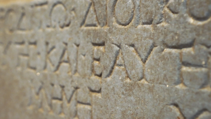 Ancient Greek manuscript engraved in a stone wall. Inscription written in ancient Greek. High quality 4k footage Royalty-Free Stock Footage #1093230533