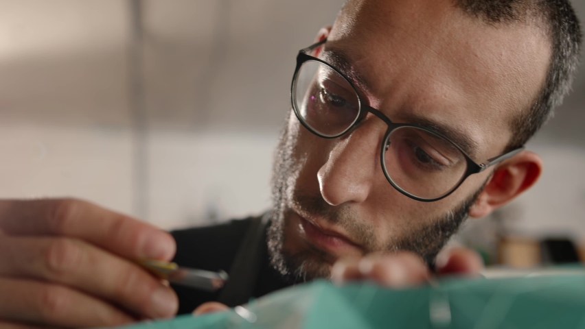 Close-up: man works with a blade. Production of decorative elements. Workshop.