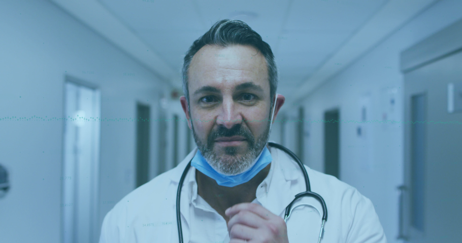 Animation of data processing over portrait of caucasian male doctor wearing a face mask at hospital. Medical healthcare and technology concept | Shutterstock HD Video #1093237989