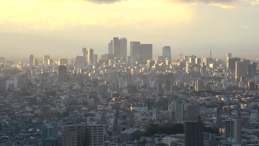 NAGOYA, AICHI, JAPAN - FEB 2020 : Aerial high angle sunset or sunrise view of cityscape of Nagoya city. View of buildings and street traffic around central downtown area.