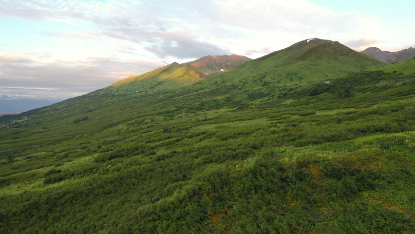 Aerial view of Hatcher Pass, Alaska. Mountain pass through the Talkeetna Mountains from above. Summer Alaskan landscape 