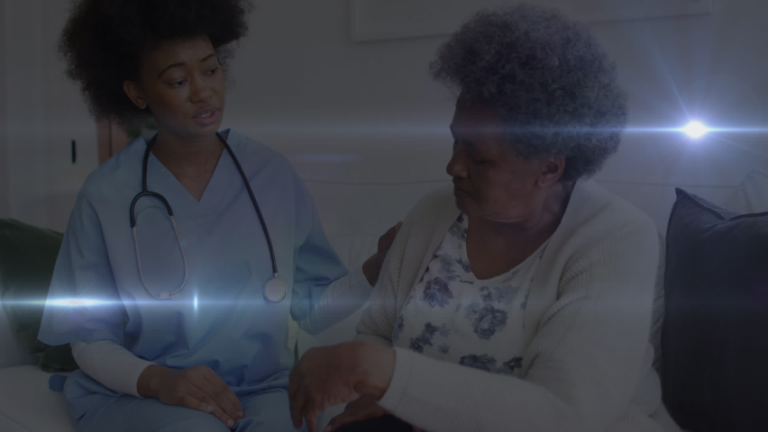 Animation of digital lights moving over african american doctor talking with patient in hospital. Digital composite, glowing, consoling, retirement, healthcare and medical concept. | Shutterstock HD Video #1093241985