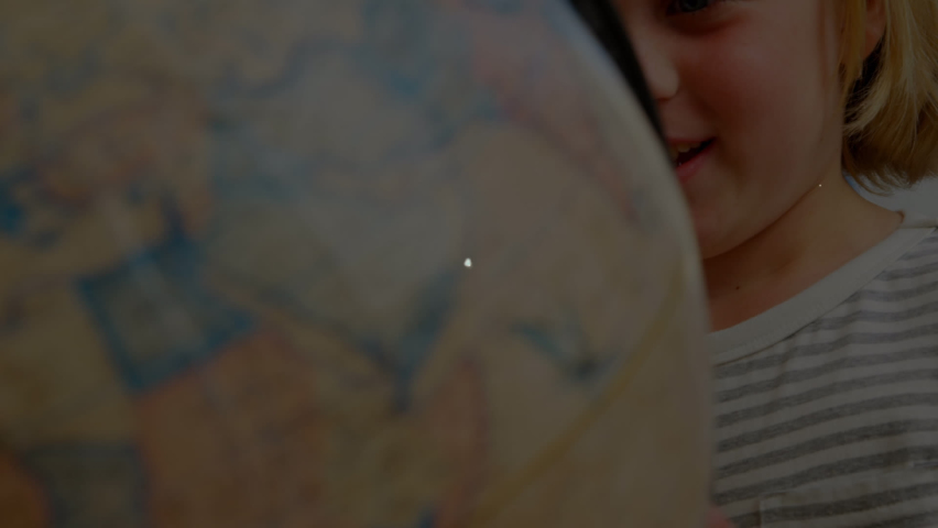 Animation of network of connections with icons over happy caucasian girl with globe at school. learning geography, education, connections and technology concept digitally generated video. | Shutterstock HD Video #1093253975
