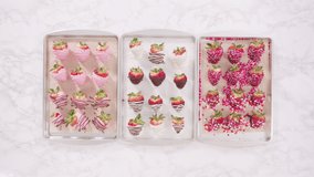 Time lapse. Flat lay. Step by step. Variety of chocolate dipped strawberries on a parchment paper.