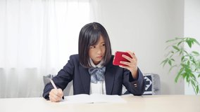 Asian female student studying with a smart phone. Online class. e-learning.