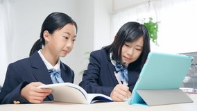 Asian schoolgirls studying with a tablet PC. Online class. e-learning.