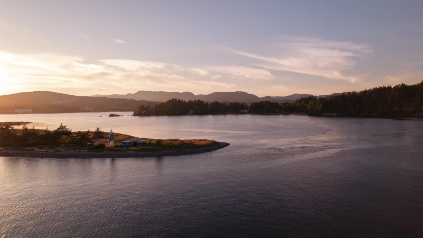 Aerial hyperlapse of ocean sunset, peninsula, boats in harbour, peaceful ocean sunset, Whiffen Spit, Sooke, Vancouver Island. 4K 24FPS