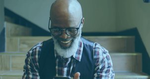 Animation of data processing on screens over happy senior african american man with smartphone. Lifestyle, data processing, communication and technology concept digitally generated video.