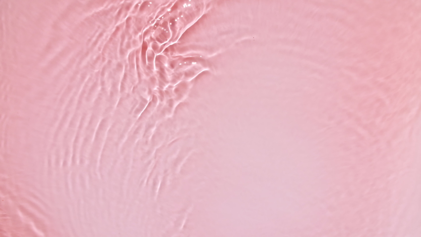 Pure pink water with reflections sunlight in slow motion. Water surface texture. Sun and shadows. Motion clean swimming pool ripples and wave. Royalty-Free Stock Footage #1093269395